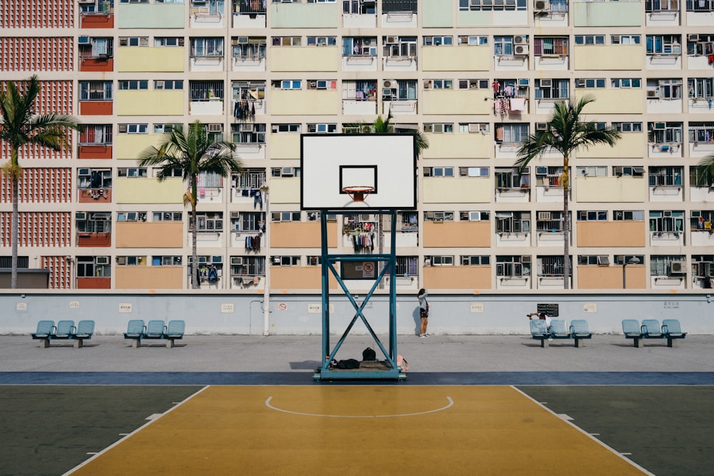 basketball court against tenement