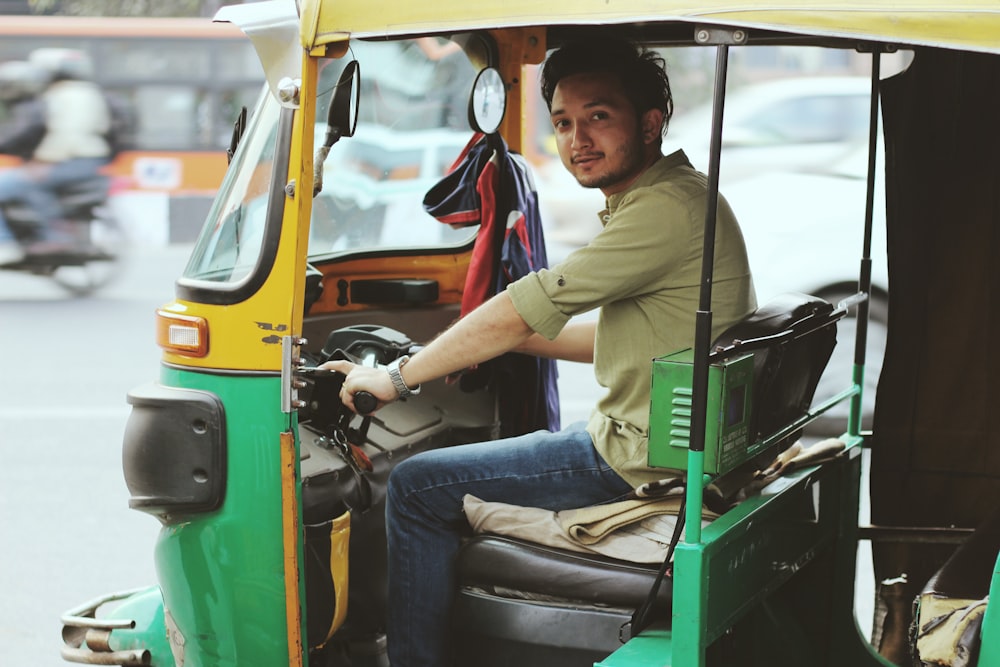 man riding on auto rickshaw
