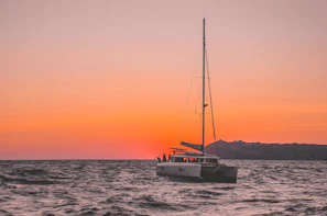 Elegant sailboat cutting through gentle waves at sunset