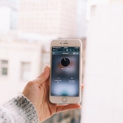 person's hand holding silver iPhone 6