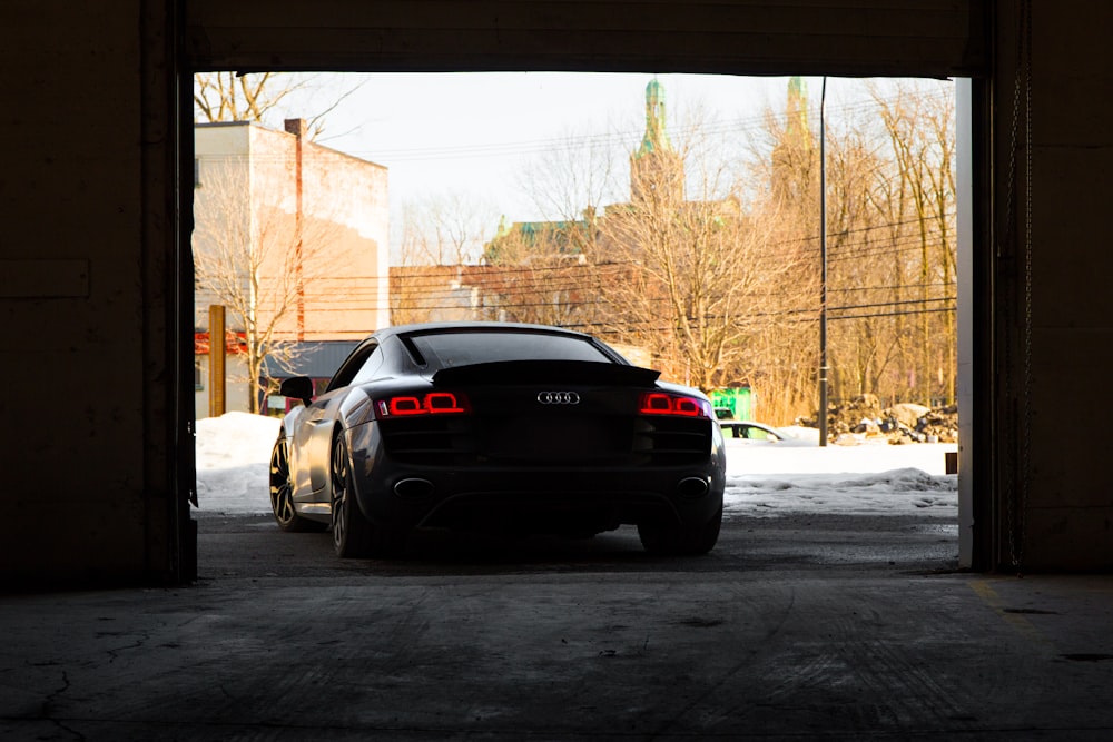 silver car beside wall