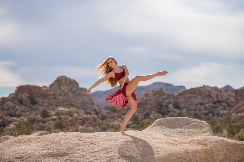 woman dancing on brown hill during daytime