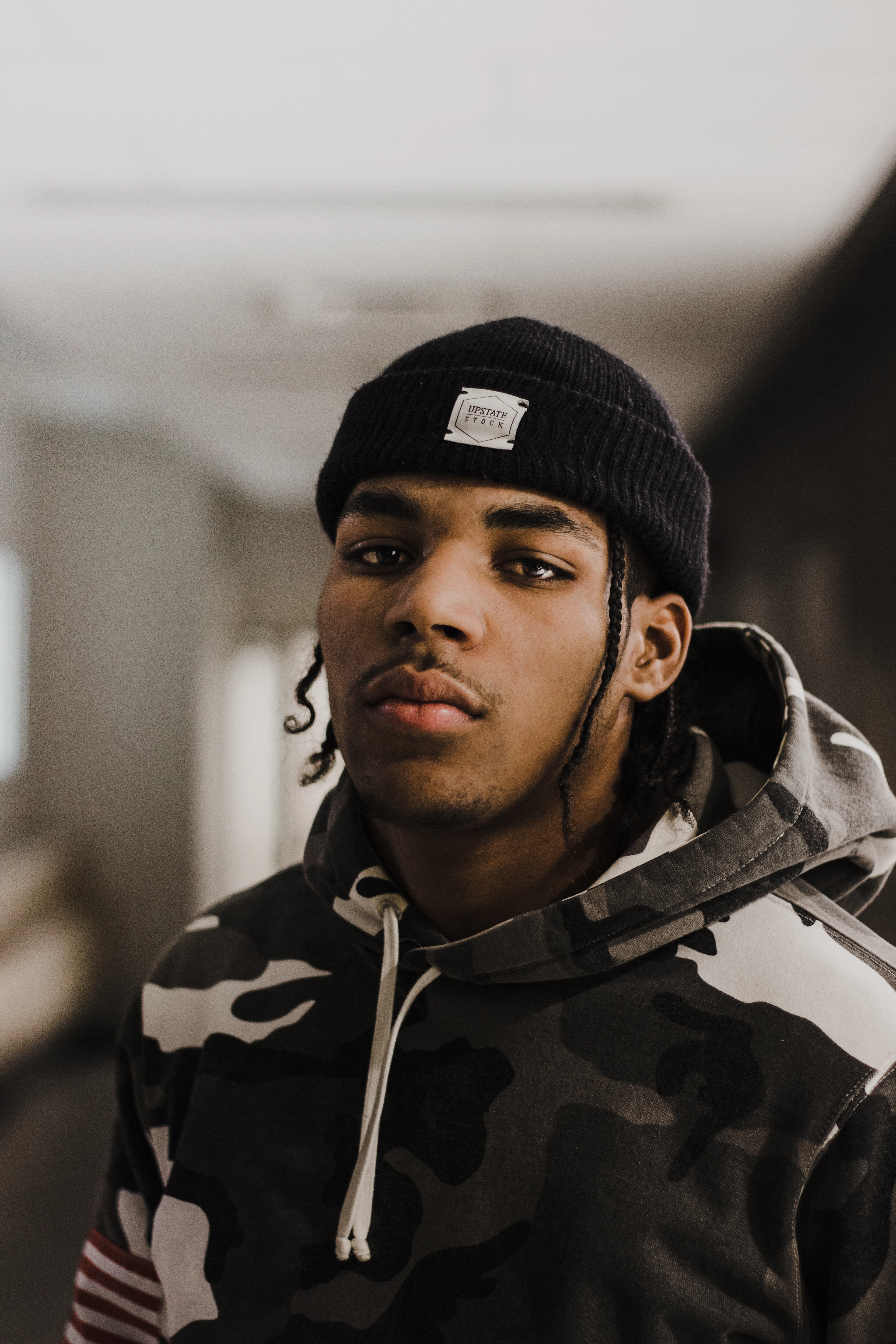 A street portrait in a knitted beanie