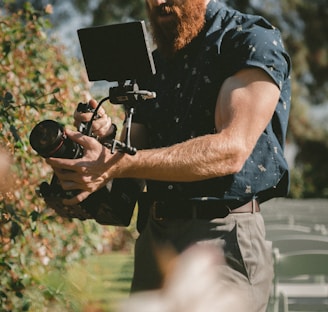 man holding camera taking photos