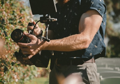 man holding camera taking photos