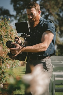 man holding camera taking photos
