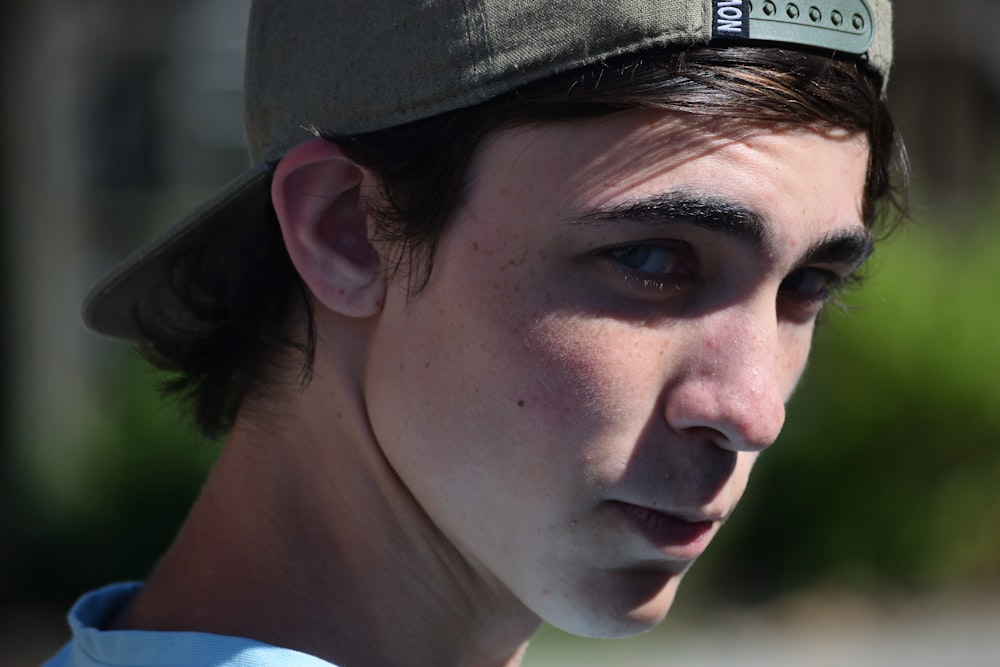 a close up of a person wearing a hat