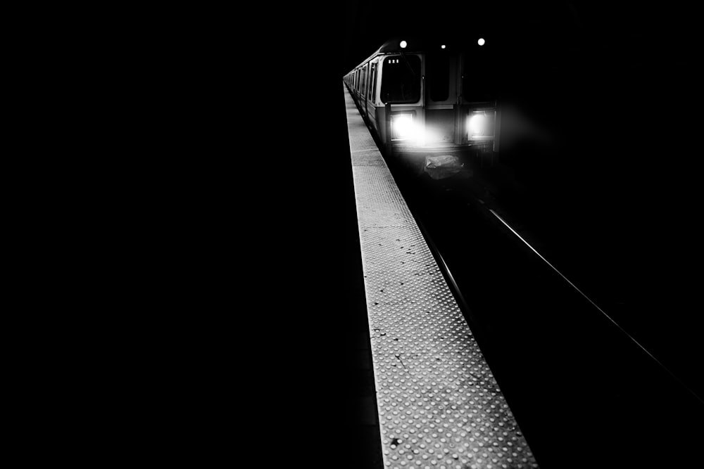 a train traveling down train tracks at night