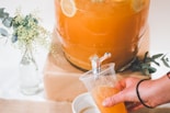 person holding clear plastic cup