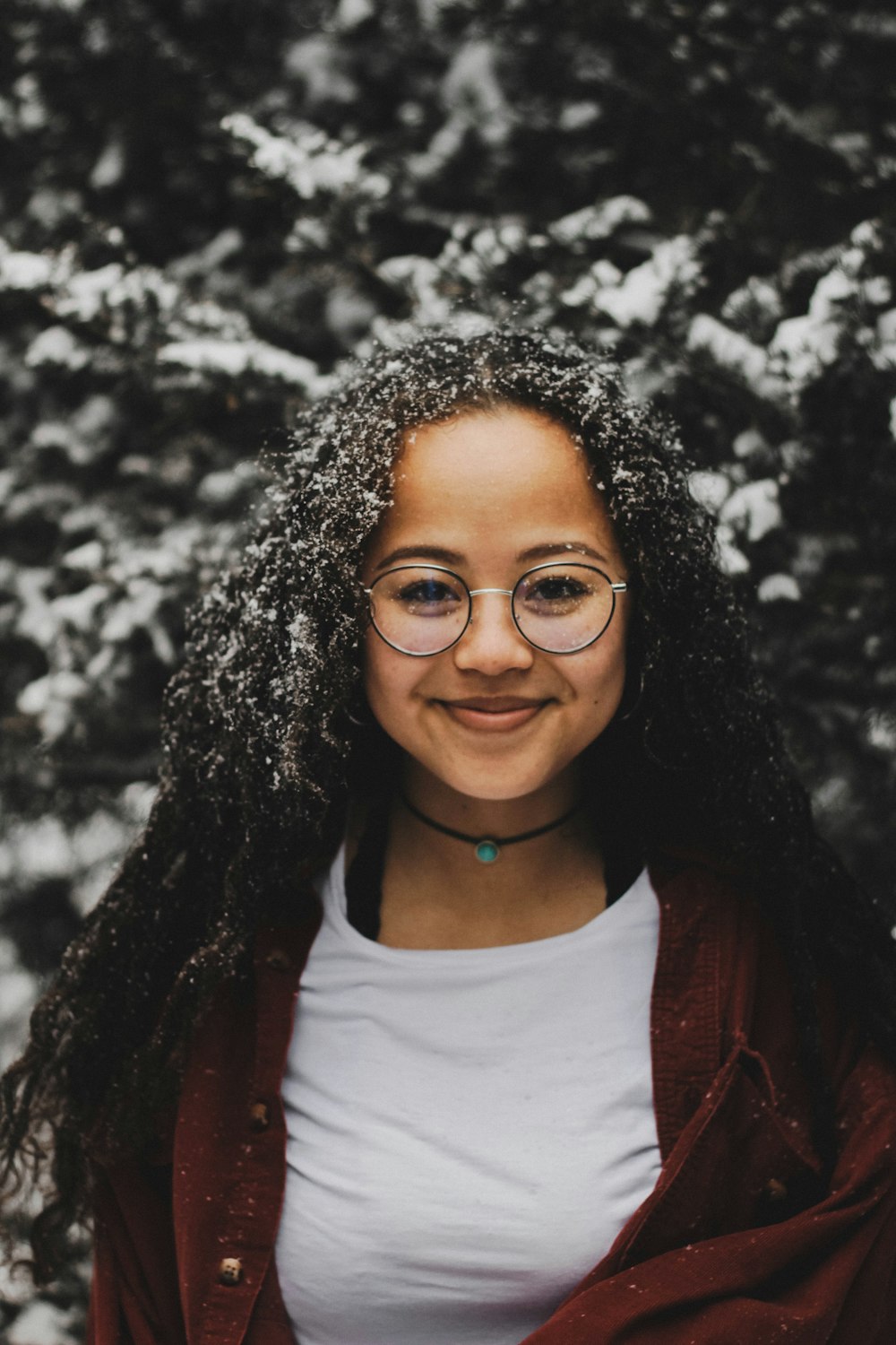 woman wearing black-framed eyeglasses and white crew-neck t-shirt