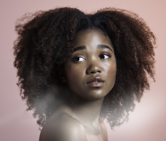 a woman with an afro is looking at the camera