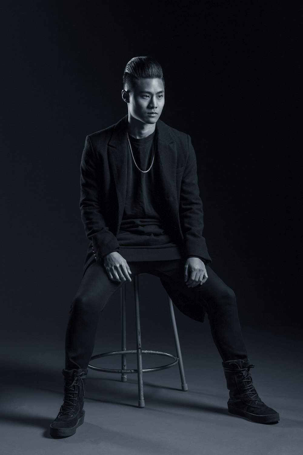 man sitting on stool inside room