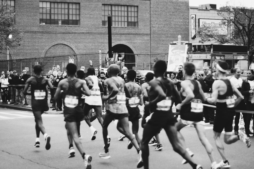 grayscale photo of men running on marathon
