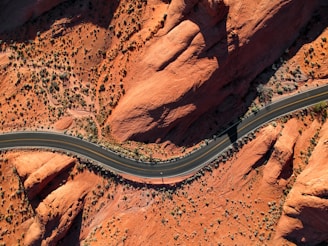 aerial photography of concrete road near rock mountain