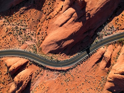 aerial photography of concrete road near rock mountain