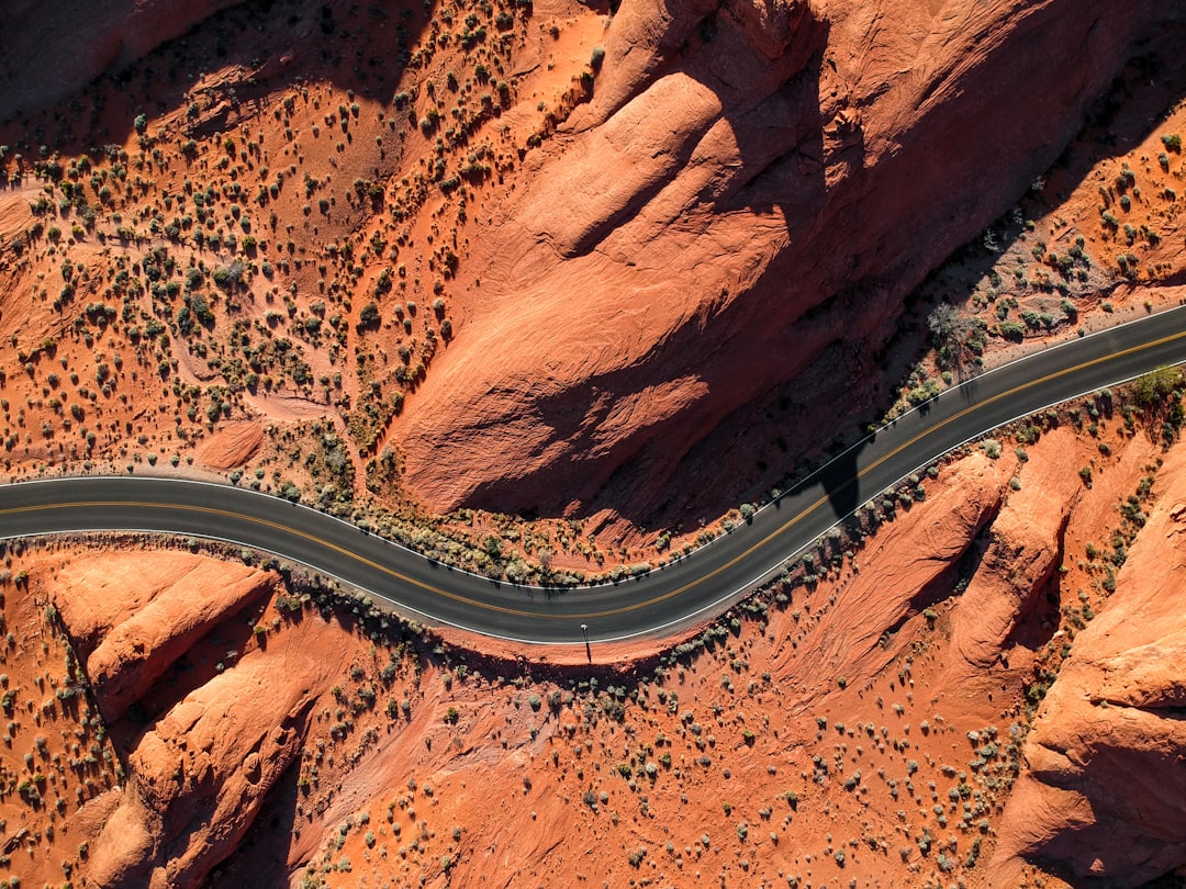 aerial photography of concrete road near rock mountain, Birds eye view roadways from Nevada