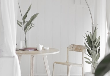 white steel chair in front round table on white rug