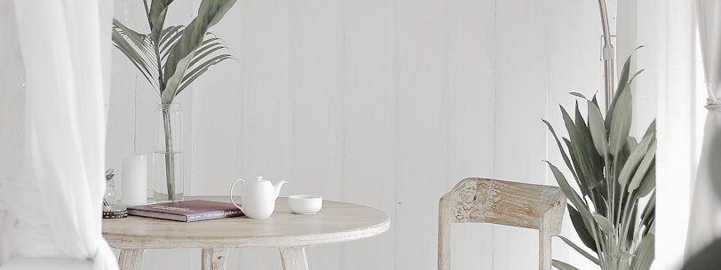 white steel chair in front round table on white rug