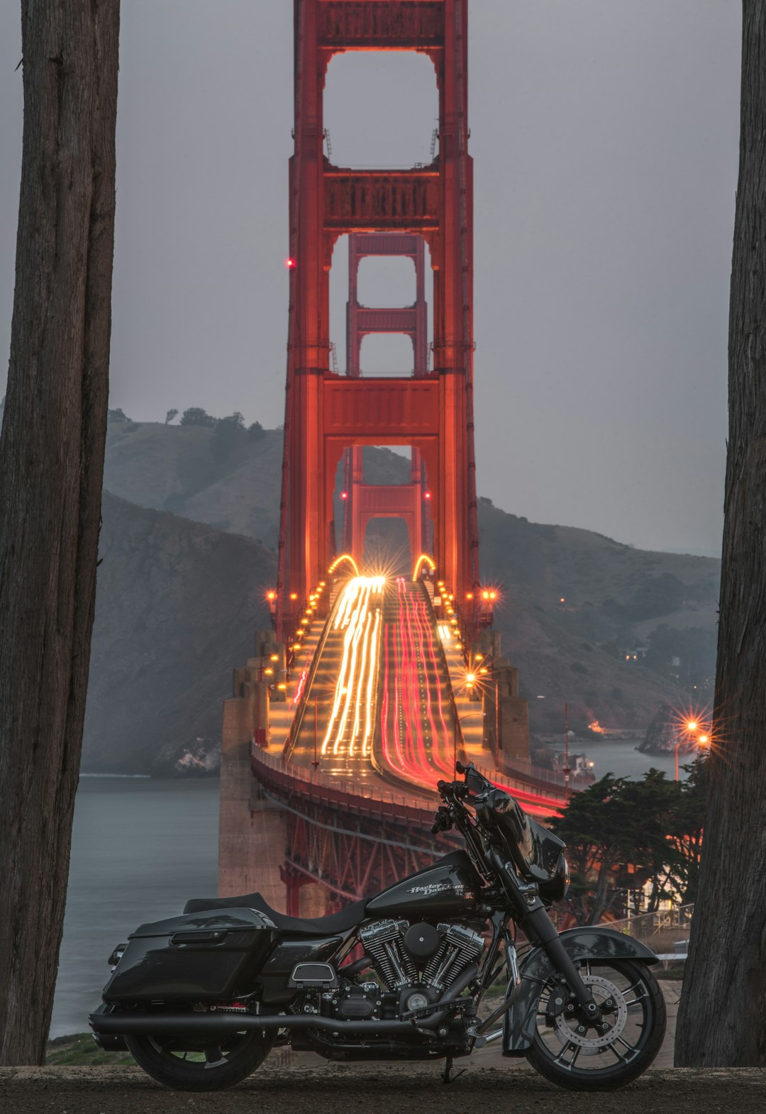 black touring motorcycle with San Francisco bridge on background