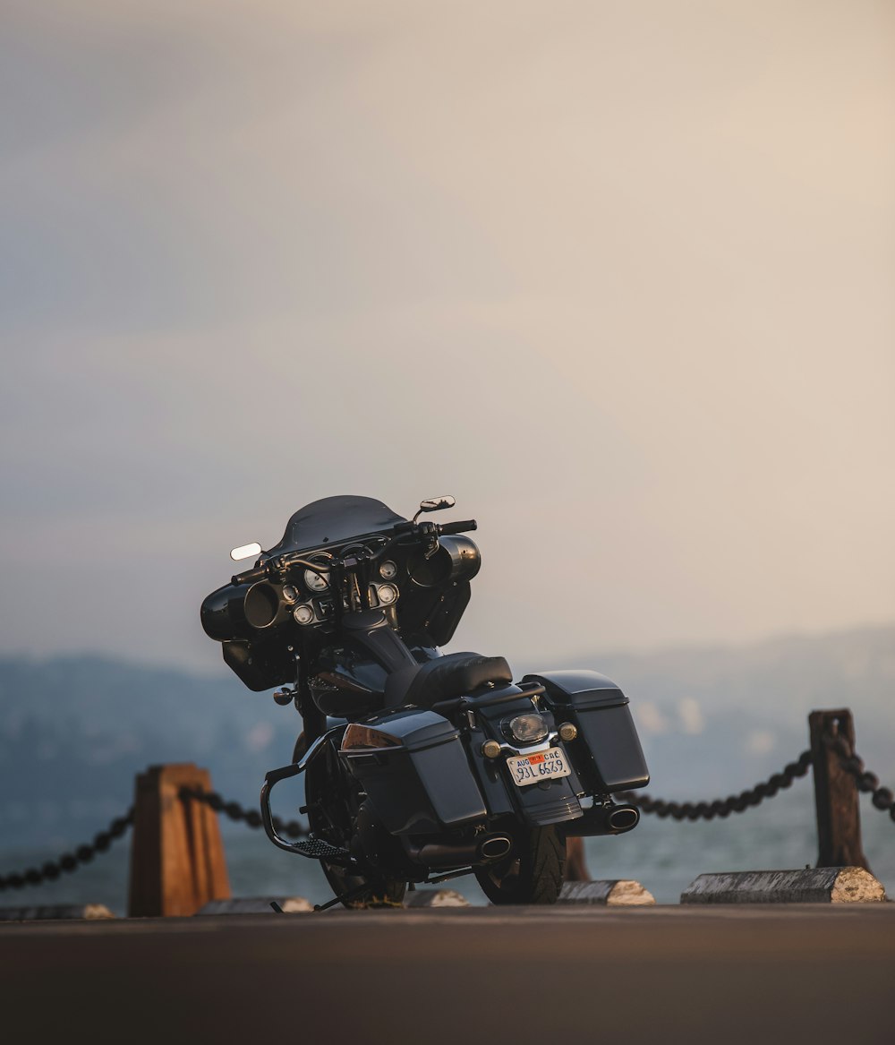 black touring motorcycle parked on dock during daytime