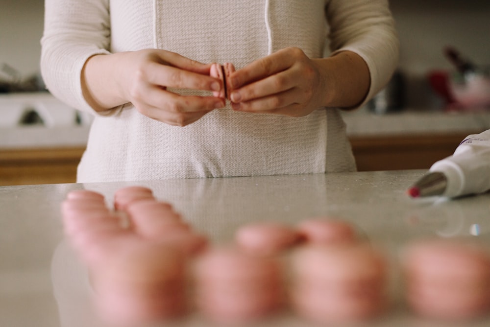 person making biscuit sandwiches