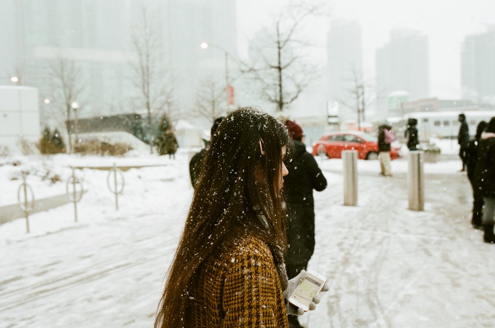 woman walking in snow covered street