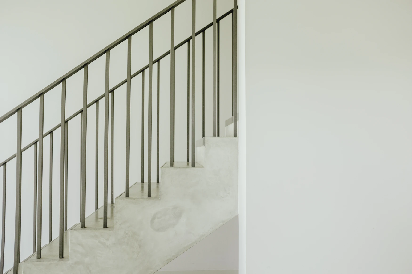 Staircase with a gray steel handrail