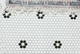 Luxurious rug with geometric patterns in monochrome tones laid in a spacious room.