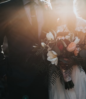 groom beside bride holding bouquet flowers