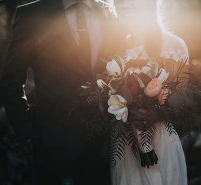 groom beside bride holding bouquet flowers