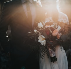 groom beside bride holding bouquet flowers