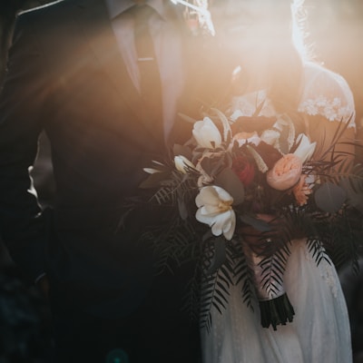 groom beside bride holding bouquet flowers