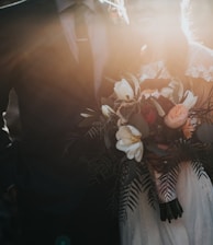 groom beside bride holding bouquet flowers