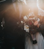 groom beside bride holding bouquet flowers