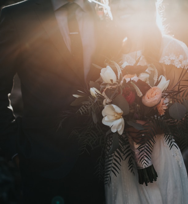 groom beside bride holding bouquet flowers