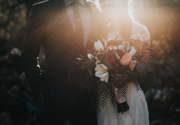 groom beside bride holding bouquet flowers