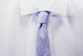 close up photo white collared shirt with blue necktie