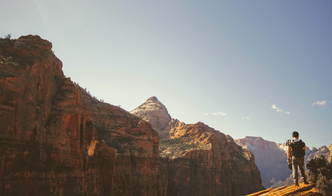 man standing on top of mountain