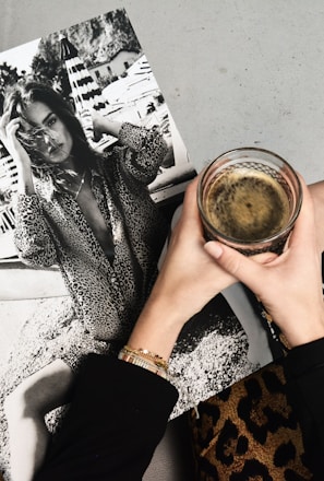 woman holding clear glass candle holder and grayscale portrait of a woman