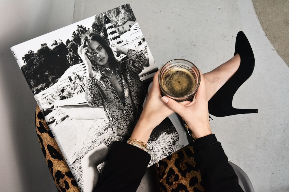 woman holding clear glass candle holder and grayscale portrait of a woman