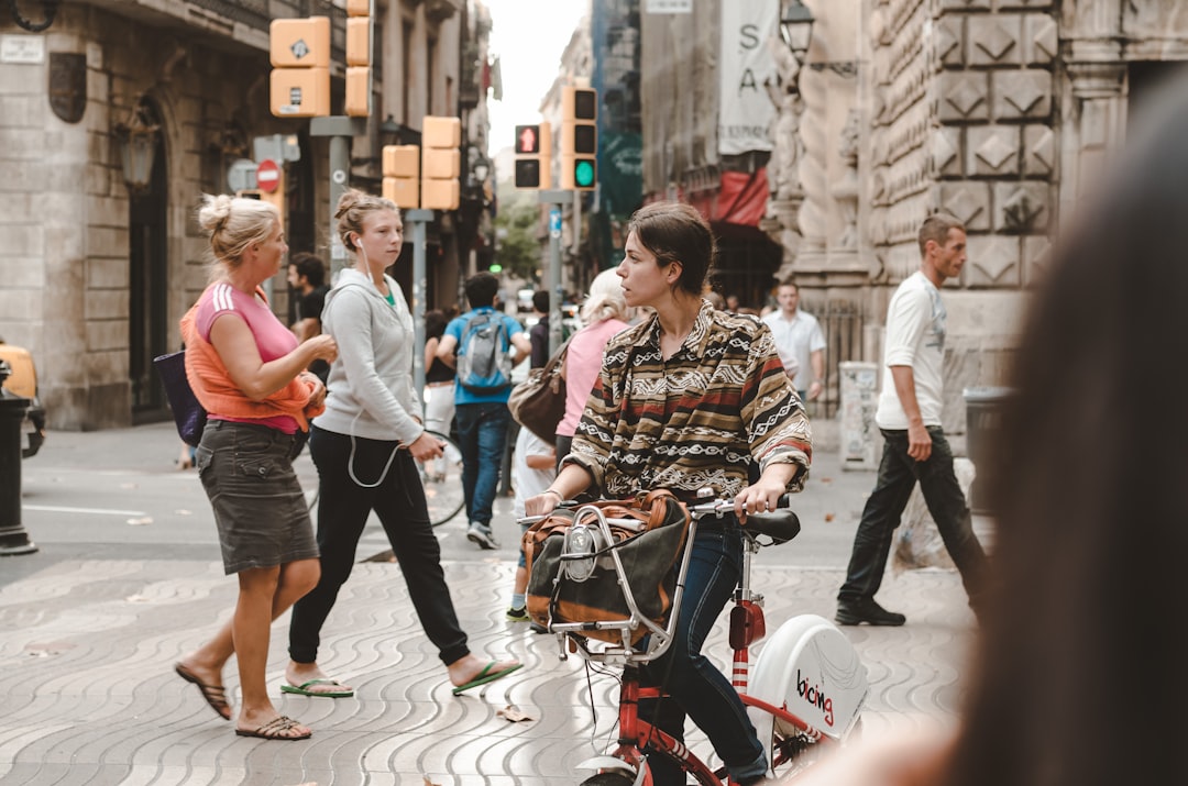 woman in black jeans riding on bicycle, Ones in Barcelona