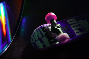 Aesthetic shot of pink and golden hour styled merchandise including t-shirts and CDs