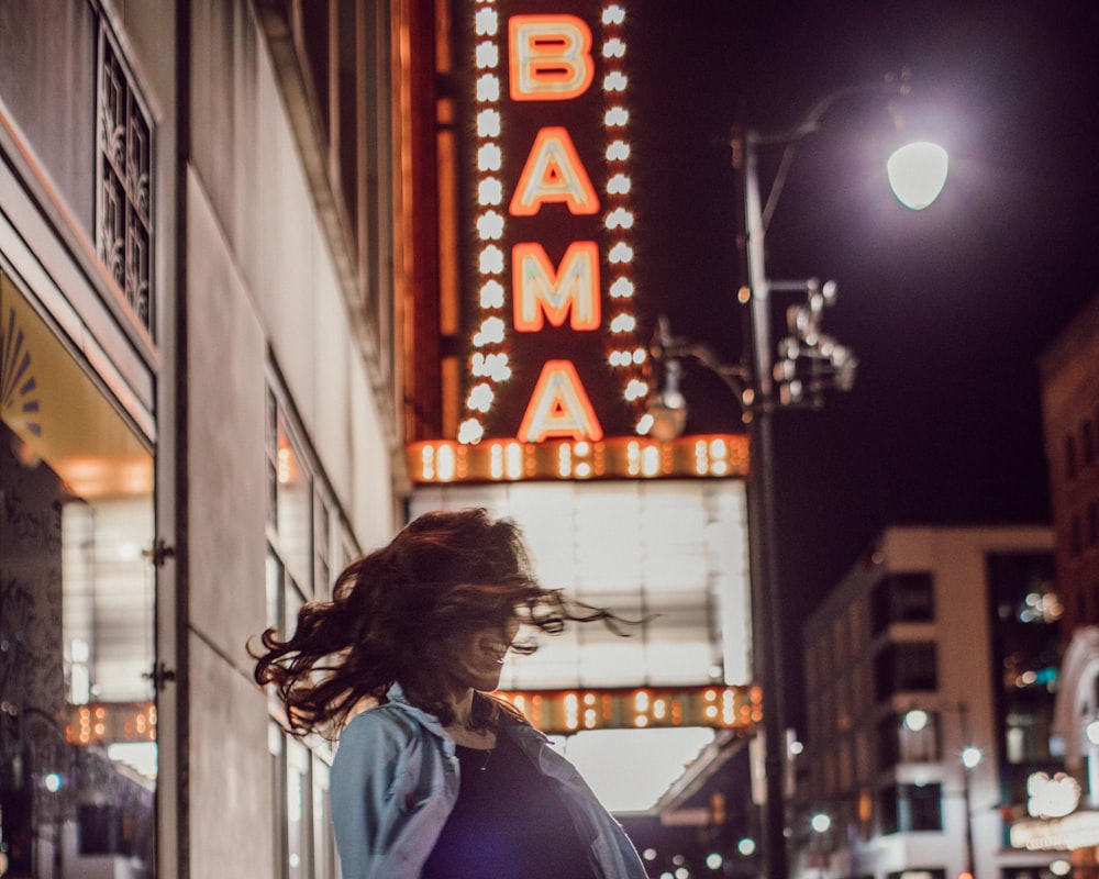 woman shaking her head near post lamp