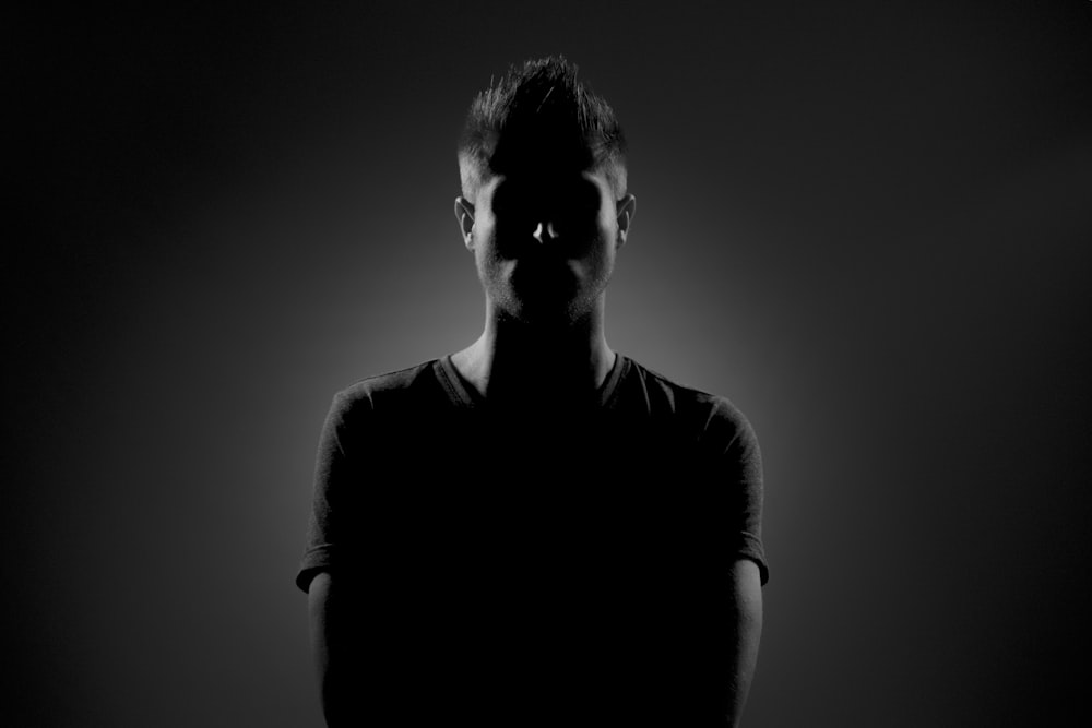 grayscale photography of man wearing black t-shirt