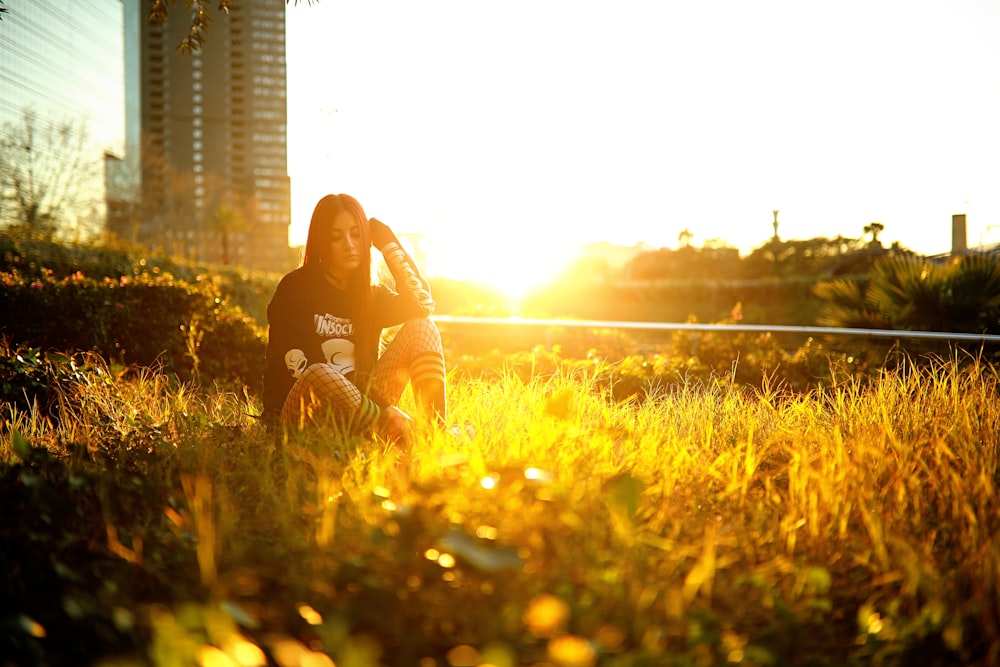 woman sitting on grass field