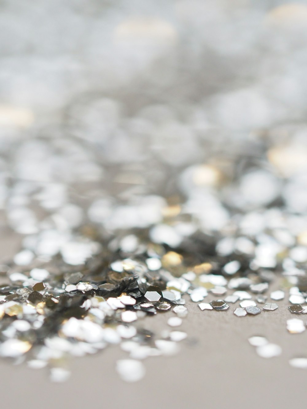 a close up of silver glitter on a table