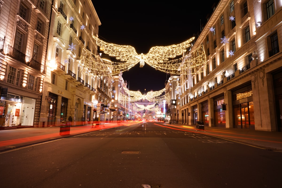 String lights over a city street decorated for the holidays