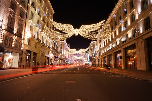 String lights over a city street decorated for the holidays