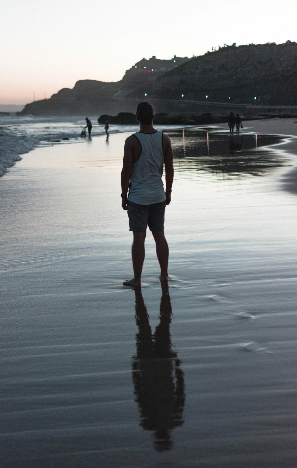 man standing on gray sand during daytime