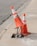 two traffic cones on gray road